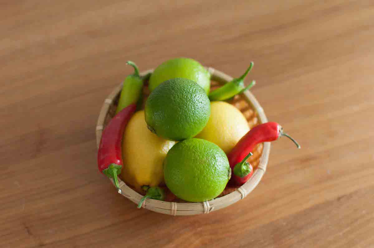 Limes, chilies and lemons in a basket