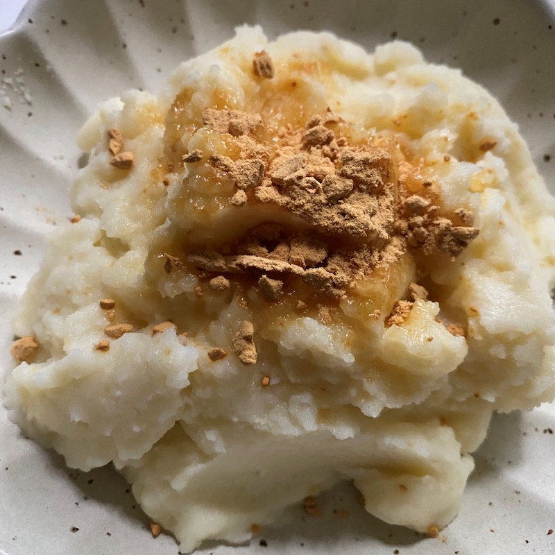 Mashed potato with soy sauce powder on a white plate