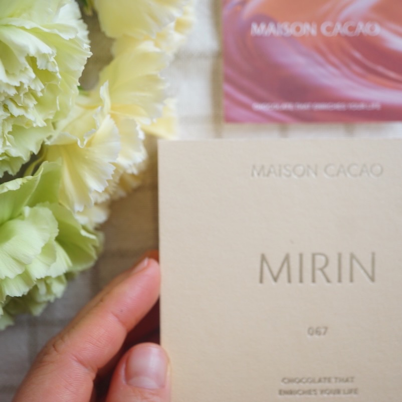 A box of Maison Cacao mirin chocolate touched by hand