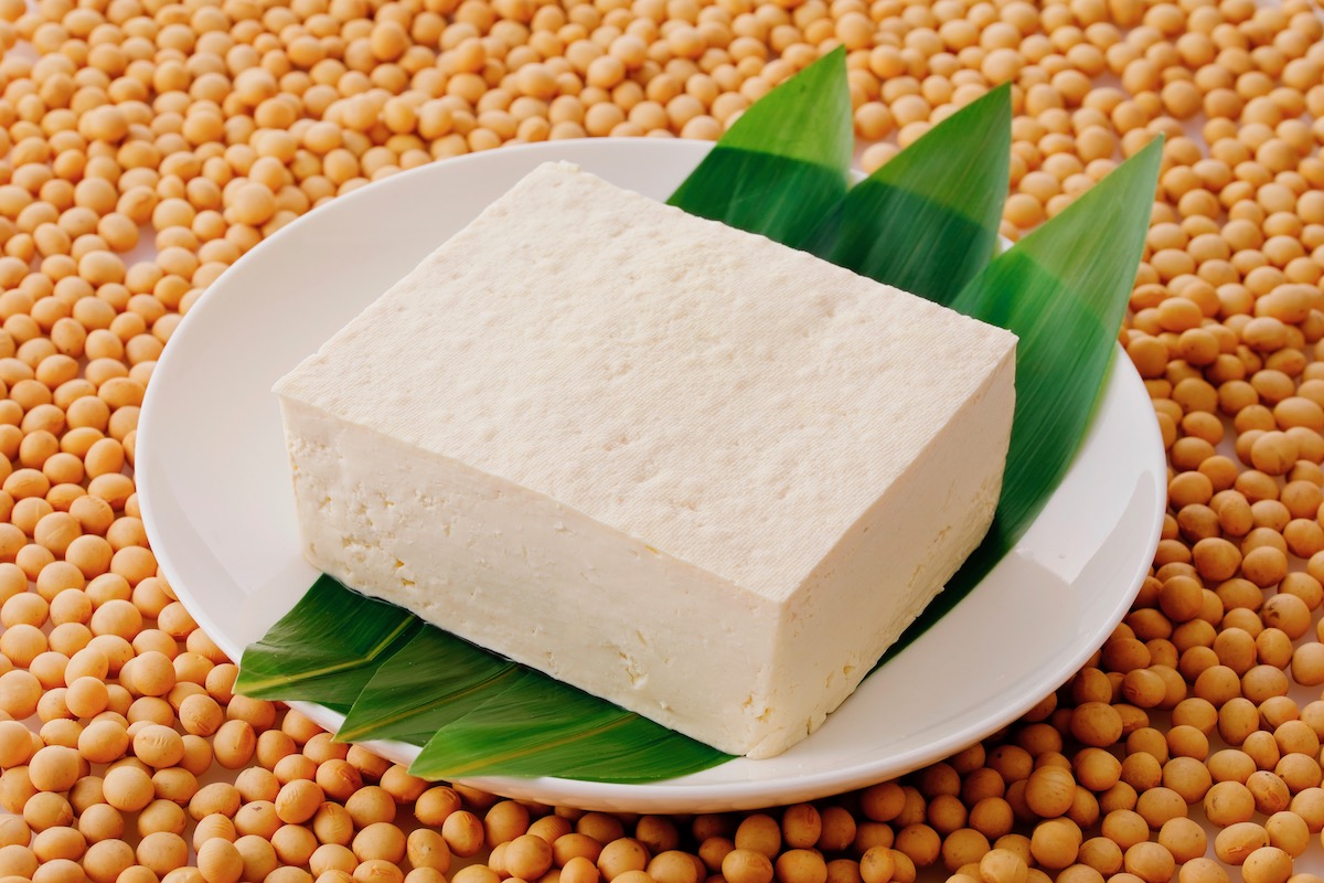 Tofu on green leaves on a plate on soy beans